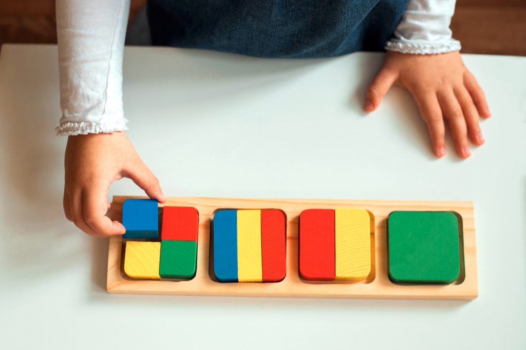 Children's hands with mathematics materials in a Montessori classroom