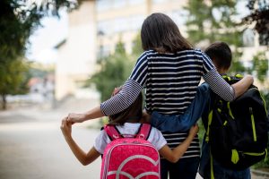 Mother walking two children to school