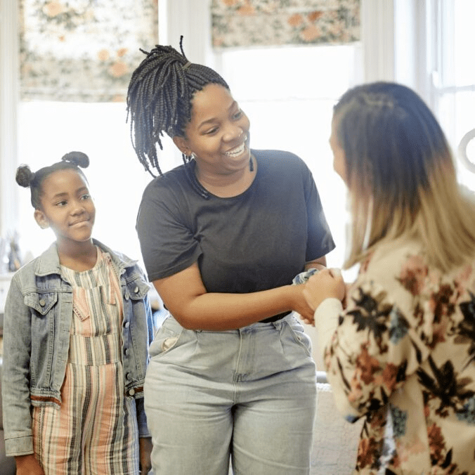 A Montessori teach meeting a parent.